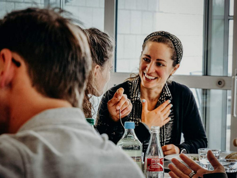 3 people engaged in conversation